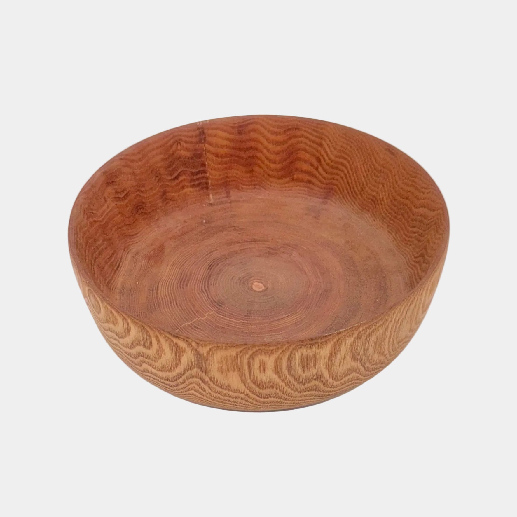 Wooden bowl with a textured surface on a white background